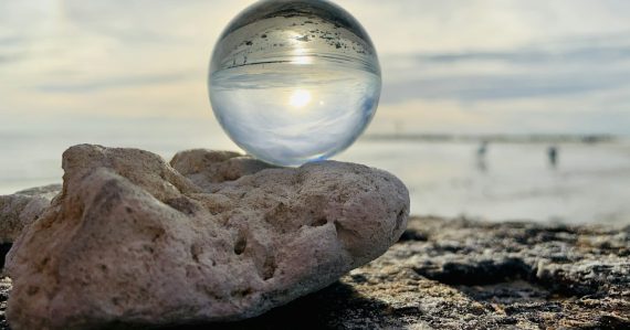 Clear glass ball on brown rock, illustrating cloud computing predictions for 2011