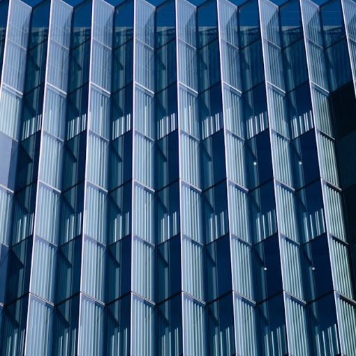 Blue and white concrete building, illustrating federal savings from moving to the cloud
