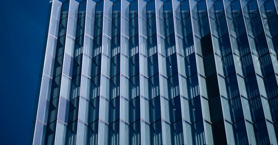 Blue and white concrete building, illustrating federal savings from moving to the cloud