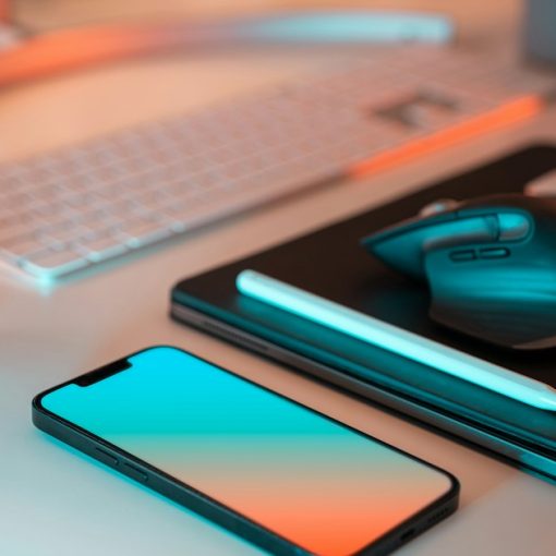 A laptop, mouse, and cell phone on a desk, illustrating what virtualization lets you do