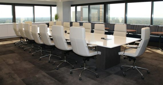 Empty boardroom with white office chairs, illustrating board of directors cloud governance