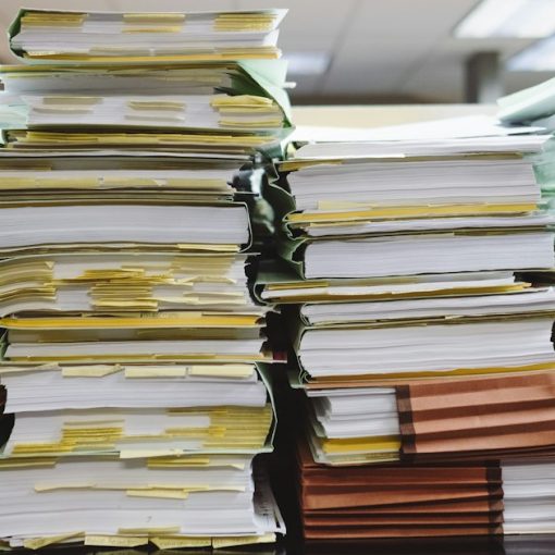 Stacks of paper documents and file folders, illustrating protecting business data from leaks