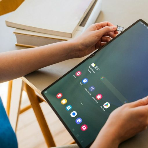 A woman sitting at a table with a tablet, illustrating BYOD tools for the enterprise