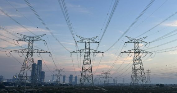A group of power lines in the middle of a city, illustrating aggregating computing capacity in the cloud