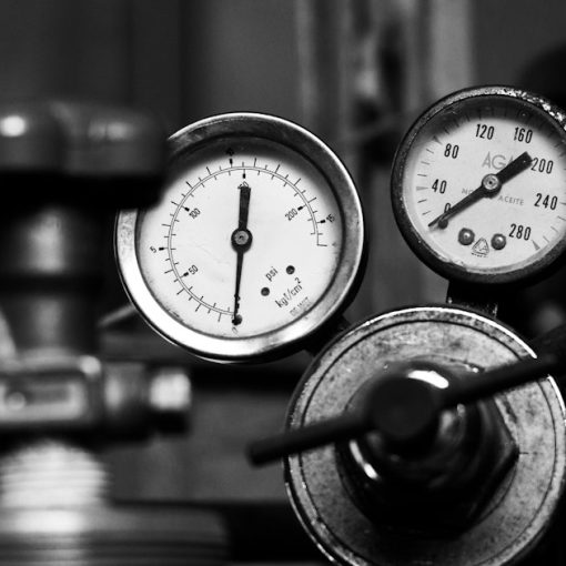 Pressure gauges and valves in monochrome, illustrating cloud capacity planning