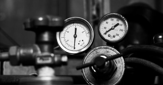 Pressure gauges and valves in monochrome, illustrating cloud capacity planning