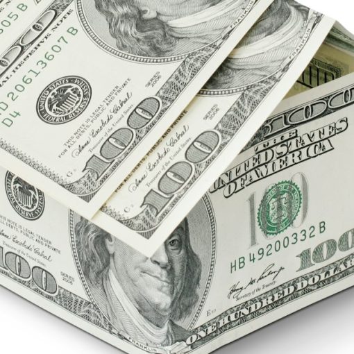 A house made out of money on a white background, illustrating capex versus opex in the cloud