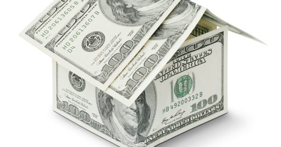 A house made out of money on a white background, illustrating capex versus opex in the cloud