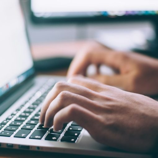 Person using MacBook Pro, illustrating client-hosted virtualization
