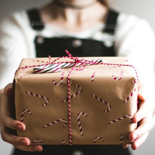 Person showing brown gift box, illustrating surprising cloud developments of 2010