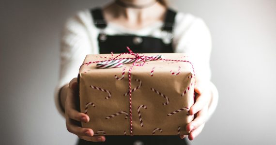 Person showing brown gift box, illustrating surprising cloud developments of 2010