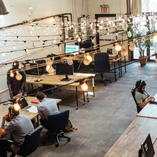 People sitting in front of computer monitors, illustrating start-ups and SMBs driving cloud adoption