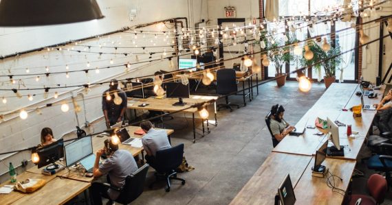 People sitting in front of computer monitors, illustrating start-ups and SMBs driving cloud adoption