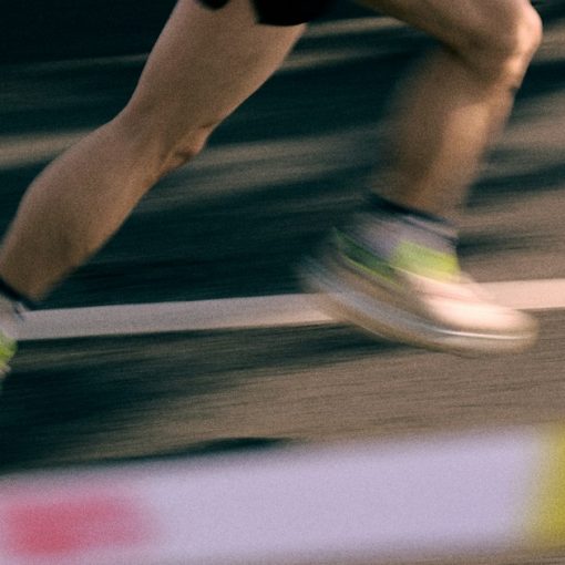 Runner's legs in motion on a track, illustrating the agility benefits of cloud computing