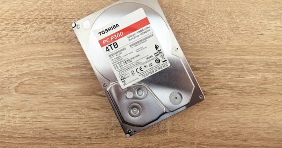 A hard drive sitting on top of a wooden table, illustrating cloud backup adoption
