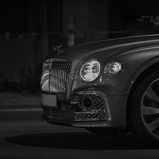 Front view of a luxury car with a chrome grille at night, illustrating cloud computing as a business necessity