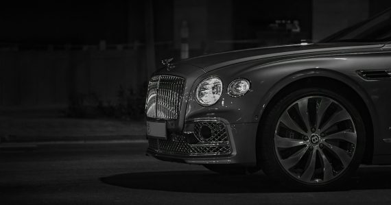 Front view of a luxury car with a chrome grille at night, illustrating cloud computing as a business necessity