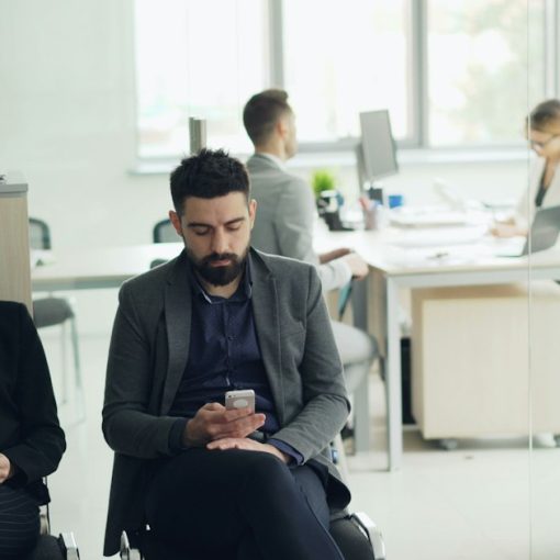 Two people waiting in an office lobby, illustrating how the cloud changes corporate IT