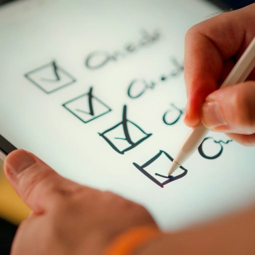 Hand ticking items off a checklist, illustrating whether your business is prepared for cloud computing