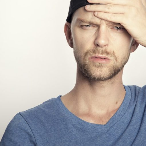 Confused man covering his face with his hand, illustrating small business confusion about cloud computing