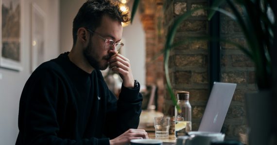 Man using a laptop, illustrating early adopters disappointed by cloud computing