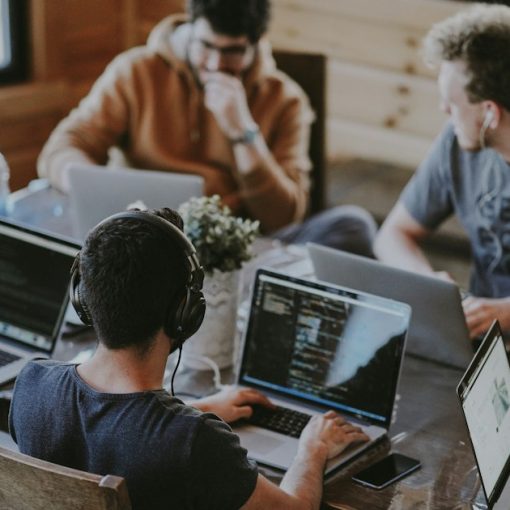 Group of people using laptop computer, illustrating ways cloud computing can help your business