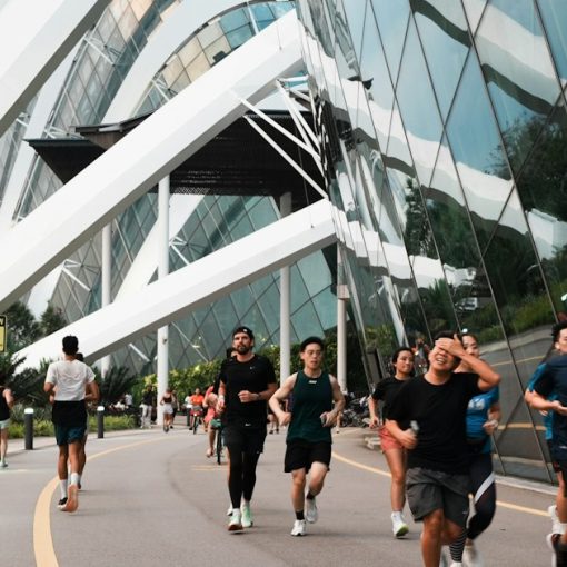 People jogging along a modern building's exterior path, illustrating business playing catch-up on cloud computing