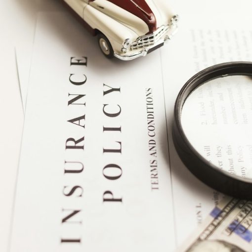 Magnifying glass on an insurance policy document, illustrating cloud computing in the insurance industry