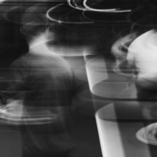 Blurred figures walking, captured in motion, illustrating the blurring of cloud service models