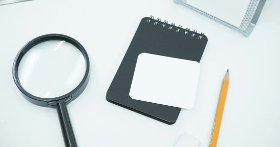 Black magnifying glass on white paper, illustrating cloud computing myths