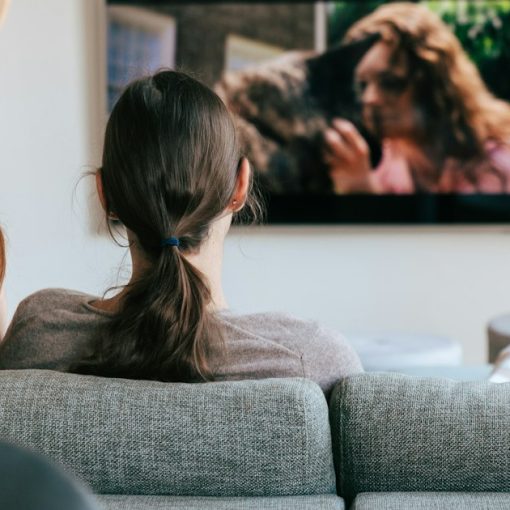 Two people on a couch watching a streaming show on TV, illustrating cloud computing in plain English