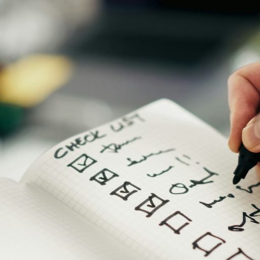 Someone is checking items off a checklist, illustrating keeping cloud projects compliant