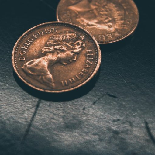Two round gold-colored coins, illustrating cloud computing versus SaaS