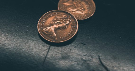 Two round gold-colored coins, illustrating cloud computing versus SaaS