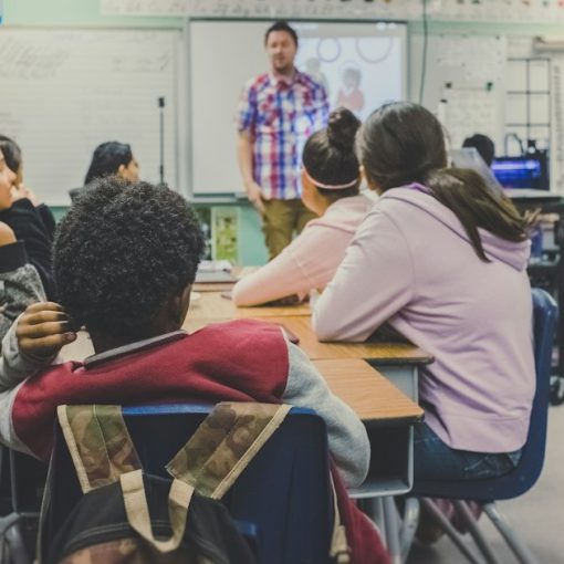 Students in classroom with teacher presenting, illustrating cloud computing for schools