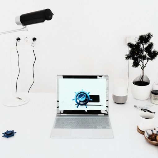A laptop computer sitting on top of a white desk, illustrating cloud computing for small business basics