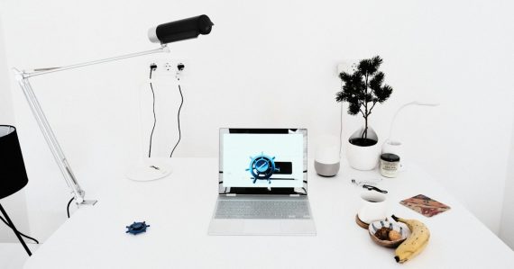 A laptop computer sitting on top of a white desk, illustrating cloud computing for small business basics