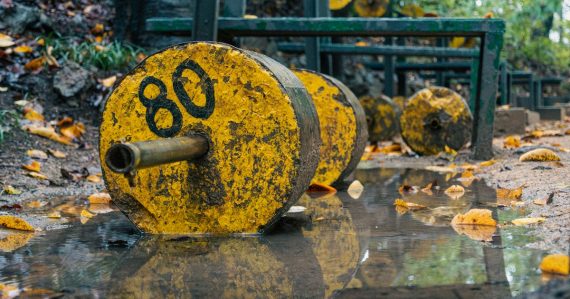 Yellow weight plates with number 80 in water, illustrating what is holding cloud computing back