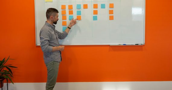 A man standing in front of a white board, illustrating why you don't need a cloud strategy