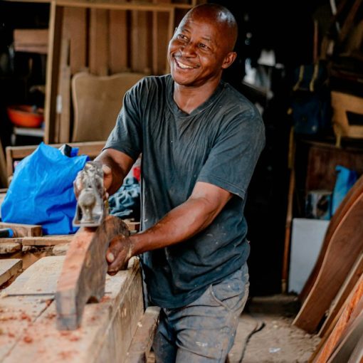 Smiling small business owner at work in his workshop, illustrating cloud computing tips for small businesses