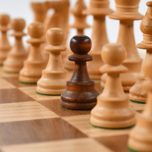 Selective focus photography of chess pieces, illustrating rising above the cloud computing war