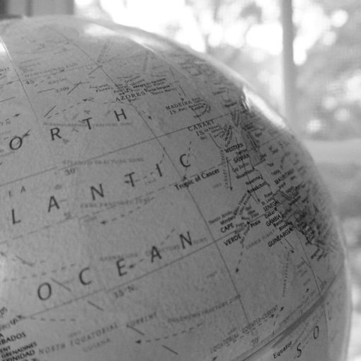 Close-up of a globe showing the Atlantic Ocean, illustrating cloud attitudes in Europe and North America
