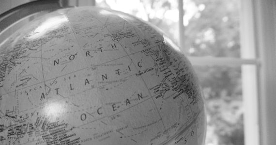 Close-up of a globe showing the Atlantic Ocean, illustrating cloud attitudes in Europe and North America