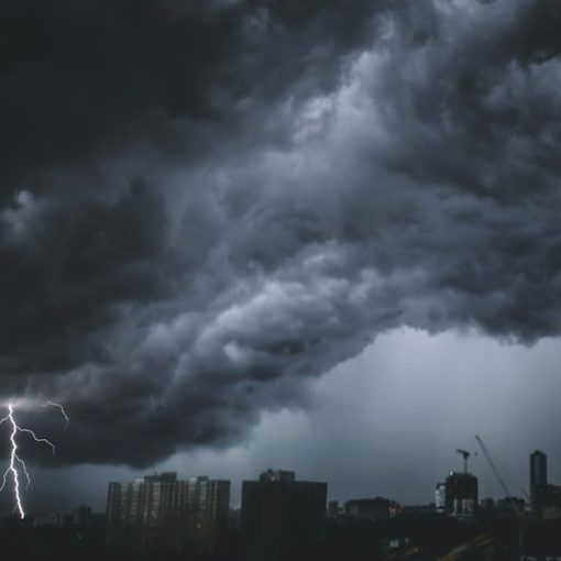 A storm coming in over a city, illustrating the federal Cloud First policy