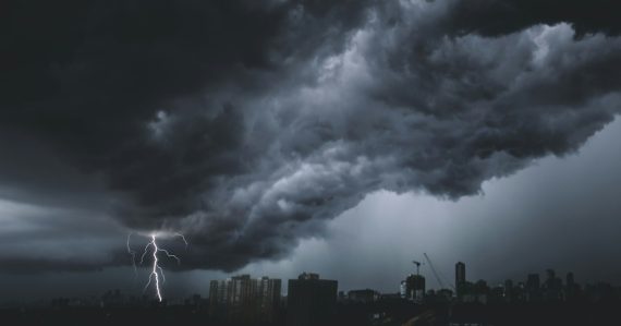 A storm coming in over a city, illustrating the federal Cloud First policy