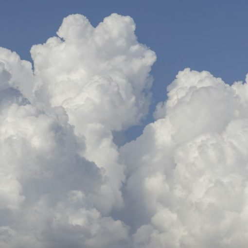 White clouds in a bright blue sky, illustrating a cloud-first strategy for business IT