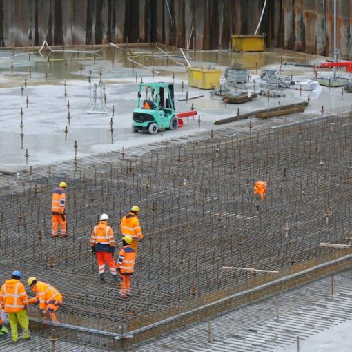 Construction workers standing around a building site, illustrating requirements for building cloud infrastructure