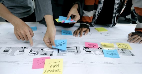 Team collaborating with sticky notes, illustrating the cloud as a driver of innovation