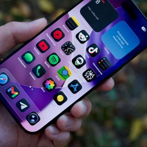 Hand holding a smartphone with colorful app icons, illustrating cloud computing's killer applications