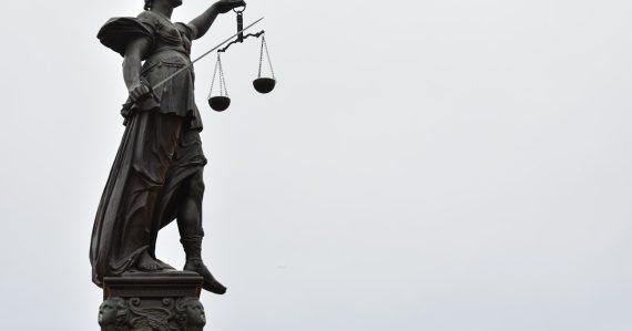 A statue of lady justice holding a scale of justice, illustrating legal issues when moving to the cloud